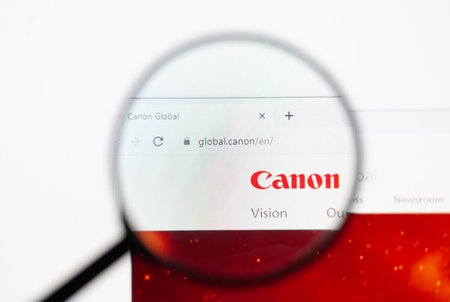 Odessa, Ukraine - December 17, 2020: Canon website on monitor screen under magnifying glass.のeditorial素材