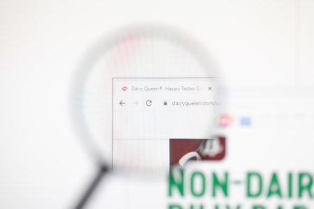 Odessa, Ukraine - December 17, 2020: Dairyqueen.com website on monitor screen under magnifying glass.のeditorial素材