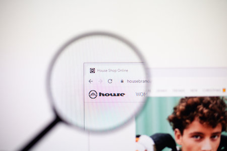 Odessa, Ukraine - December 17, 2020: House store website on monitor screen under magnifying glass.のeditorial素材