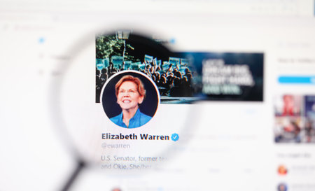 Odessa, Ukraine - December 1, 2020: Elizabeth Warren official twitter web page on screen through magnifying glassのeditorial素材