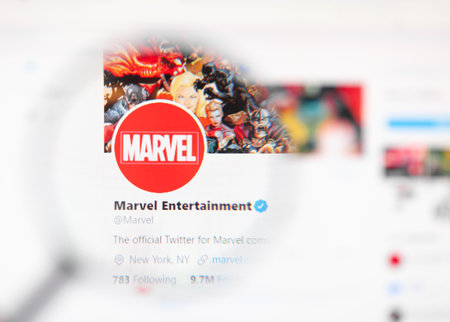 Odessa, Ukraine - December 1, 2020: Marvel entertainment official twitter web page on screen through magnifying glassのeditorial素材