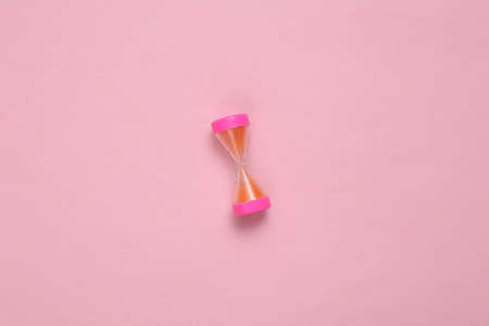 Hourglass on a pink pastel background. top view. minimalismの写真素材