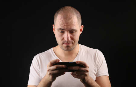 Man using smartphone on black backgroundの写真素材