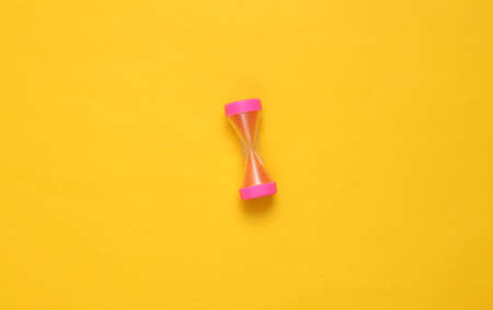 Hourglass on yellow background. top view. minimalismの写真素材