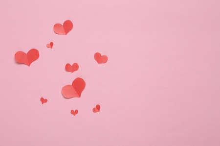 Paper Cut Red hearts on pink background. copy spaceの写真素材