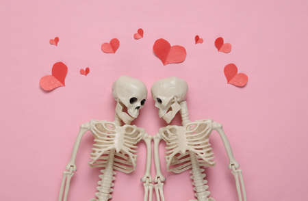 Two skeletons and red hearts on a blue background. Valentine's day, halloween conceptの写真素材