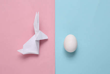 Origami easter bunny with egg blue backgroundの写真素材