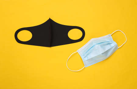 Protective face masks on yellow background. top view