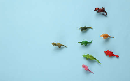 Toy dinosaurs on a blue backgroundの写真素材