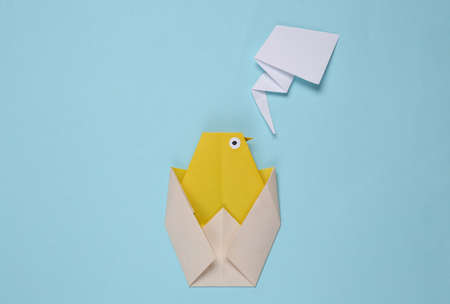 Origami chicken on a blue backgroundの写真素材