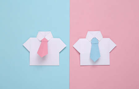 Origami shirts with ties on a blue-pink pastel background. Leadership, teamwork, business conceptの写真素材