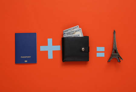 travel concept. Equation with passport, wallet and eiffel tower on orange background
