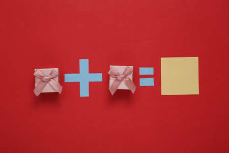 Super promotional offer. Equation from gift boxes on red backgroundの写真素材