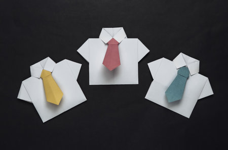 Origami shirts with ties on black background. Leadership, teamwork, business conceptの写真素材