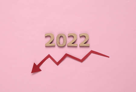 Economic crisis 2022. Arrow falling and 2022 on pink background