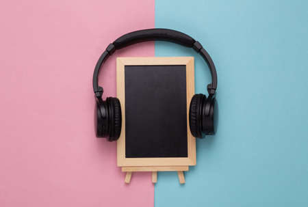 Empty chalk board with headphones on a pink blue background. copy spaceの写真素材