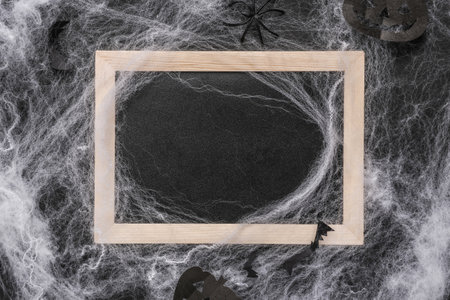 Halloween background. Frame with spider webs, bats on a black backgroundの写真素材