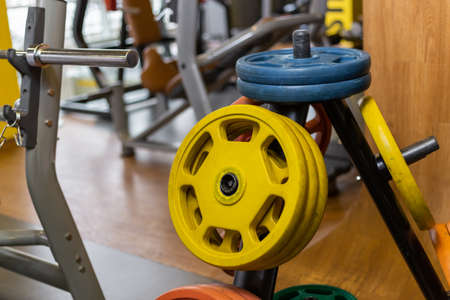 Rack with barbell discs in a modern gym