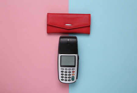 Payment terminal with red wallet on pink blue background. top viewの写真素材
