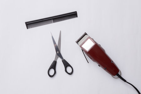 Machine for haircuts, scissors and comb on white background. Barbershop. hair clipper. top view. flat layの写真素材