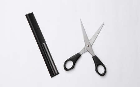 Scissors and hairbrush on a white background. Set for haircuts, hair care, barbershopの写真素材