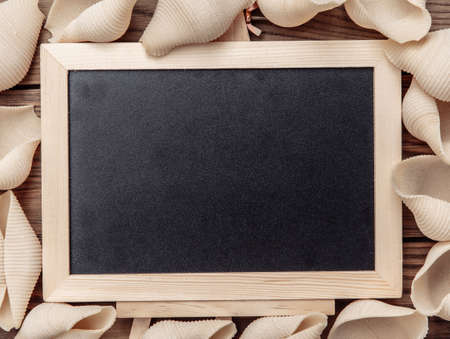 Empty chalk board and Italian pasta. copy spaceの写真素材