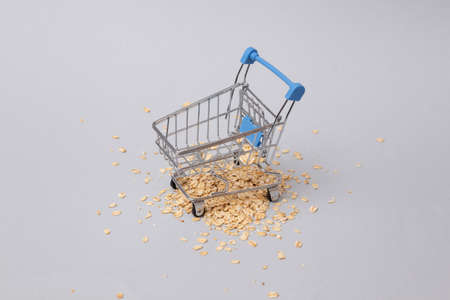 Shopping cart with oatmeal on gray backgroundの写真素材