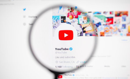Odessa, Ukraine - December 30, 2020: Youtube Official twitter web page on screen through magnifying glassのeditorial素材