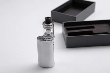 New vaping device in a box on a gray background