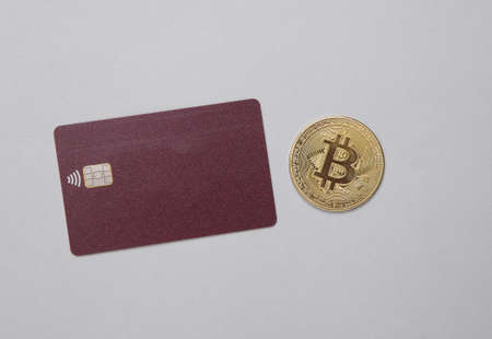Gold bitcoin on and credit card on gray background. Online payments. Cryptocurrencyの写真素材