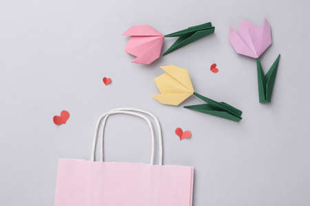 Shopping bag and hearts, tulips on a gray background. Holiday shopping, discounts, sale, valentine's day compositionの写真素材