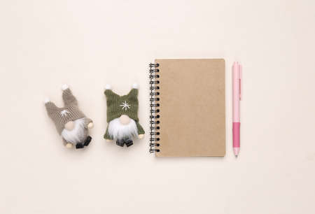 Christmas gnomes dolls and notepad on beige backgroundの写真素材