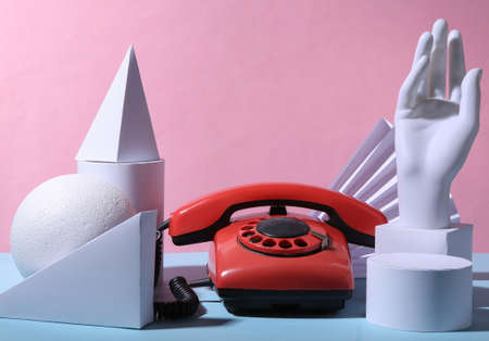 Retro rotary phone and geometric shapes on blue pink pastel background. 80s concept artの写真素材