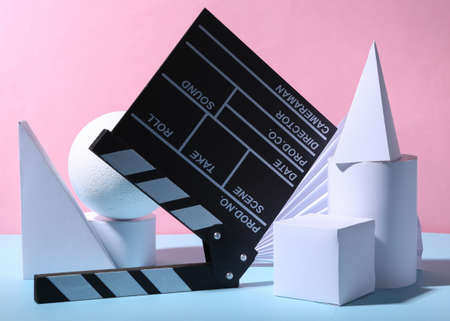 Movie clapperboard and geometric shapes on a blue-pink pastel background. concept artの写真素材