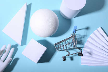 Concept art geometric composition of geometric shapes and shopping trolley on a blue bright background. minimalism. Saleの写真素材