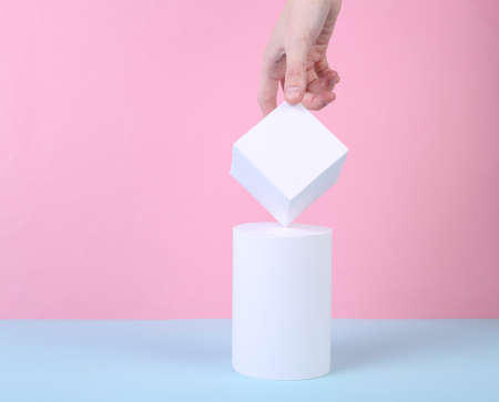 concept art concept. Female hand and geometric shapes on a blue-pink background. minimalism