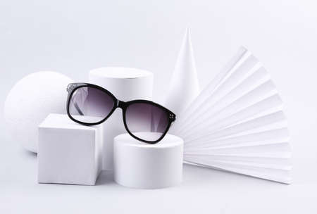 Fashion showcase with stylish sunglasses and geometric shapes on white background. concept artの写真素材
