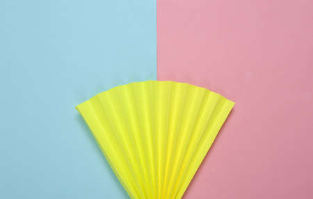 Paper fan on blue-pink pastel background. Concept art, minimalismの写真素材