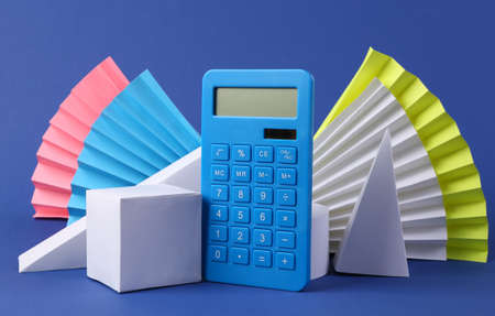 Calculator and geometric shapes on blue background. concept art.の写真素材