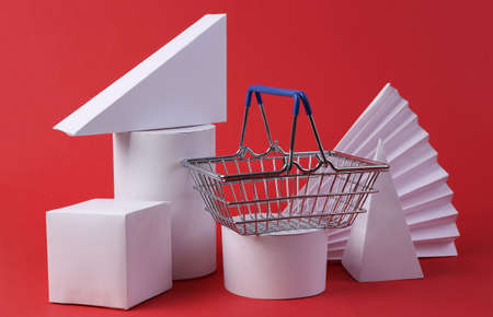 Concept art composition of geometric shapes and shopping basket on red background. minimalism. sale....