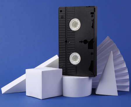 Video cassette and geometric shapes on blue background. concept art. Retro 80sの写真素材