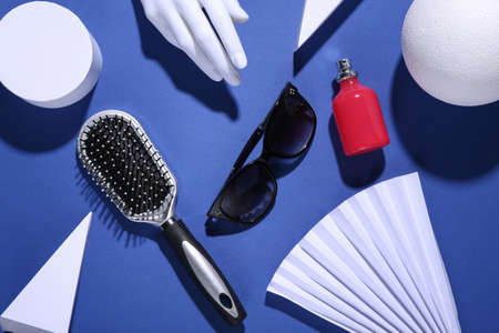 Minimalism blue background with geometric shapes and beauty womens accessories . trendy shadowsの写真素材