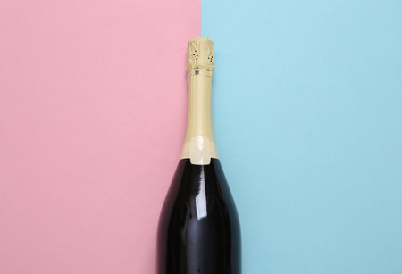 Champagne bottle on blue pink pastel backgroundの写真素材