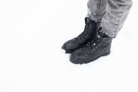 Female feet in boots in the snowの写真素材