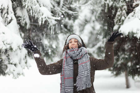 Young cheerful woman glad to snowの写真素材