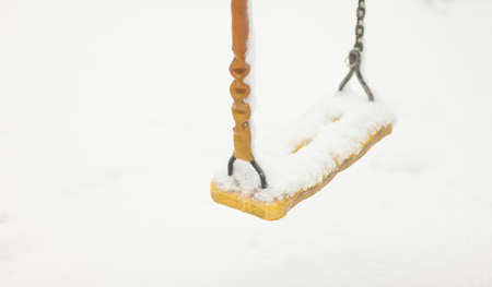 Swing in the snow. Playground in winterの写真素材