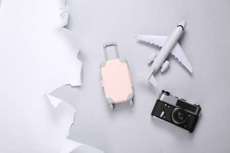 Travel accessories and torn paper sheet on gray background. travel concept. copyspace. top viewの写真素材