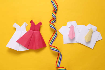 lgb community. Origami dresses and shirts with tie, rainbow ribbon on yellow backgroundの写真素材