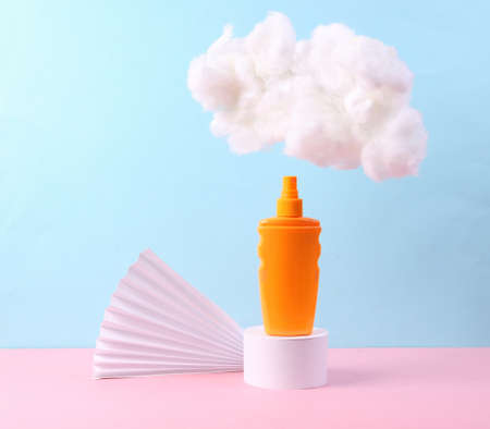 Beauty product Minimalistic showcase. Sunblock bottle on stand and cloud on a blue-pink pastel...