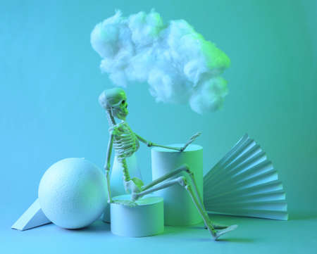 Modern abstract composition of geometric shapes, skeleton and floating fluffy cloud in blue green...